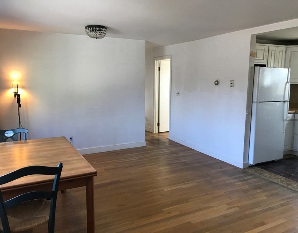 113 Peter Spring Road Concord, MA 01742 - Photo 8 of 13 a view of a kitchen with a table and chairs