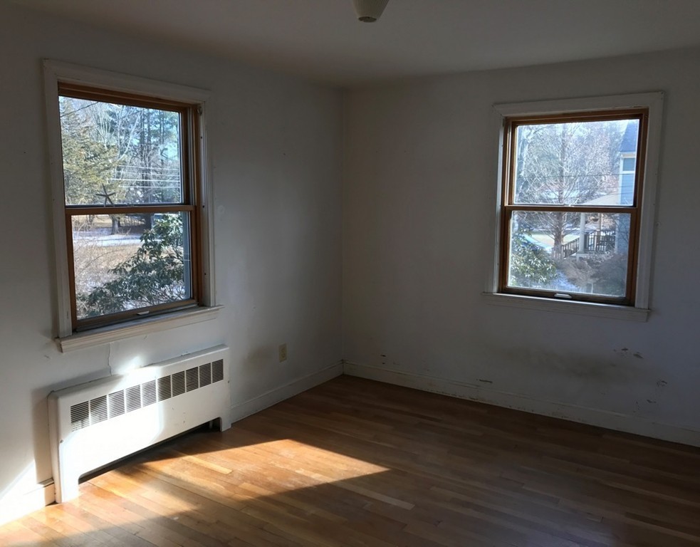 113 Peter Spring Road Concord, MA 01742 - Photo 9 of 13 an empty room with wooden floor and windows