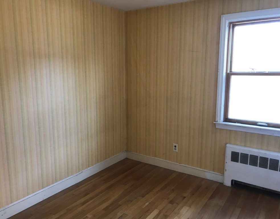 113 Peter Spring Road Concord, MA 01742 - Photo 10 of 13 a view of an empty room with wooden floor and a window