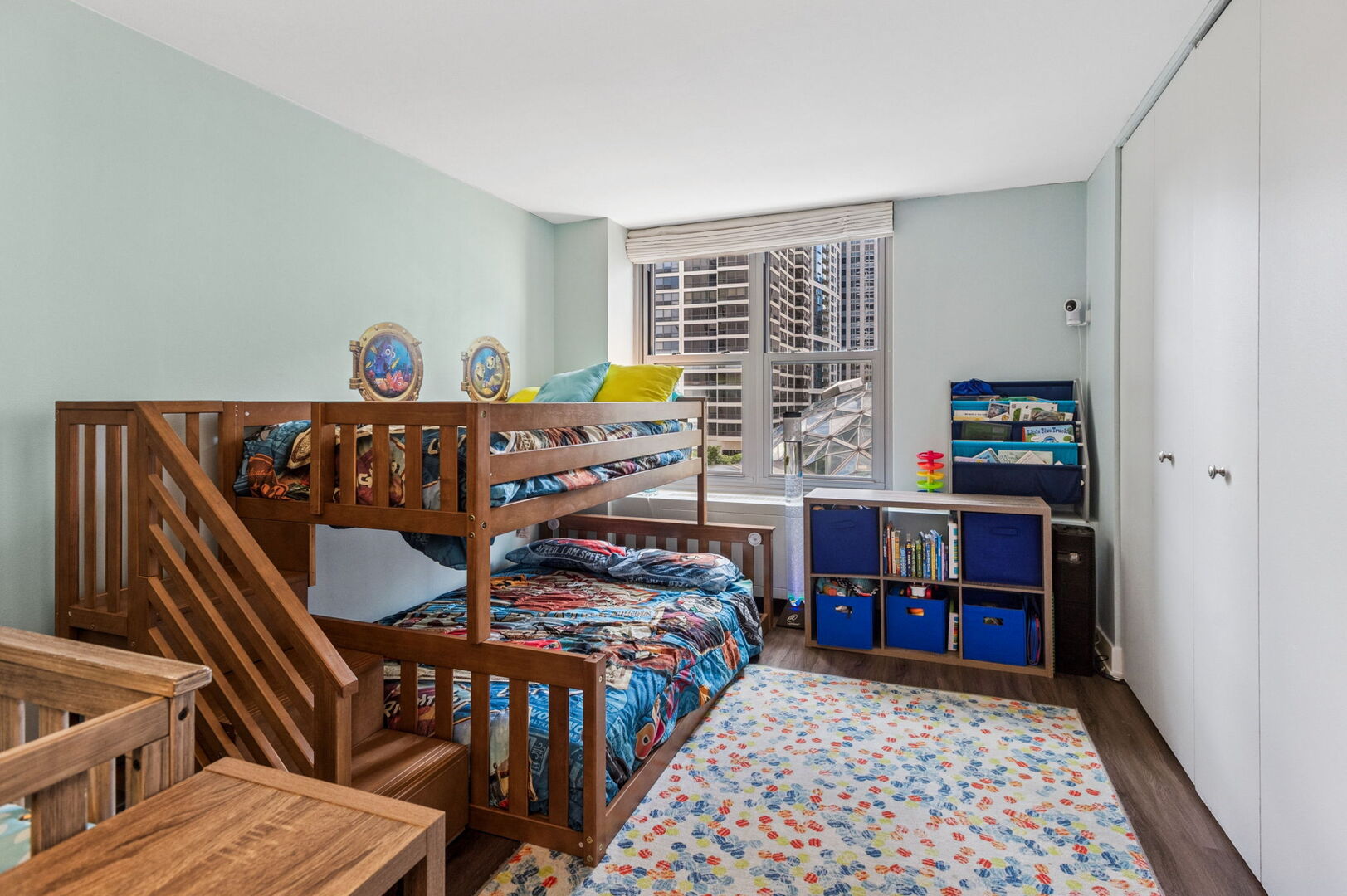 400 East Randolph Street, Unit 930 Chicago, IL 60601 - Photo 13 of 34 a bedroom with furniture and a book shelf