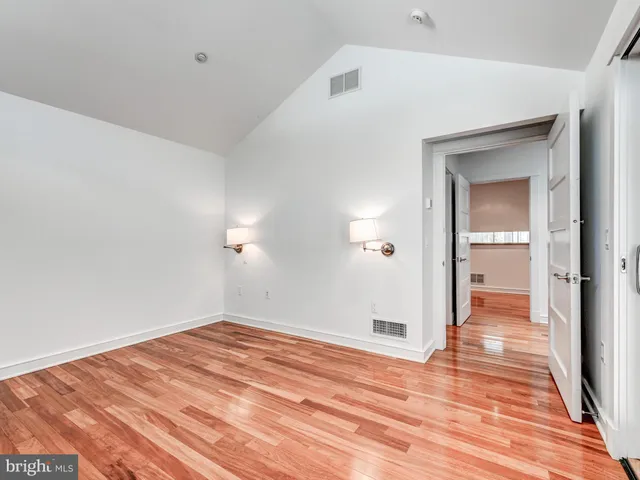 a view of a room that has a bed in it