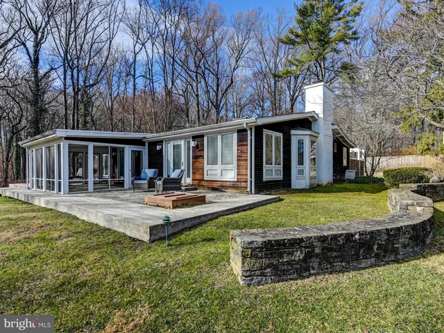 a view of a house with swimming pool and porch