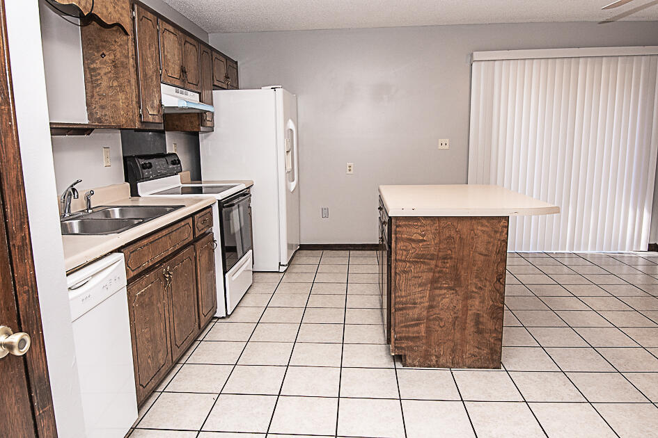 116 Walker Circle West Crestview, FL 32539 - Photo 10 of 20 a kitchen with a sink a stove top oven and cabinets