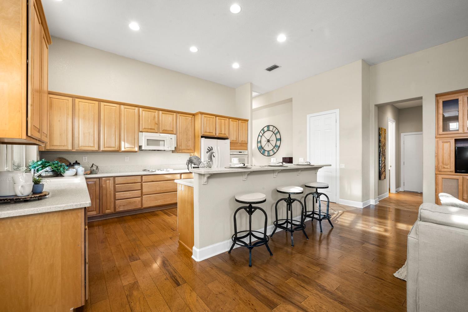 856 Mossy Ridge Lane Lincoln, CA 95648 - Photo 16 of 44 a kitchen with granite countertop a stove a sink a dining table and chairs