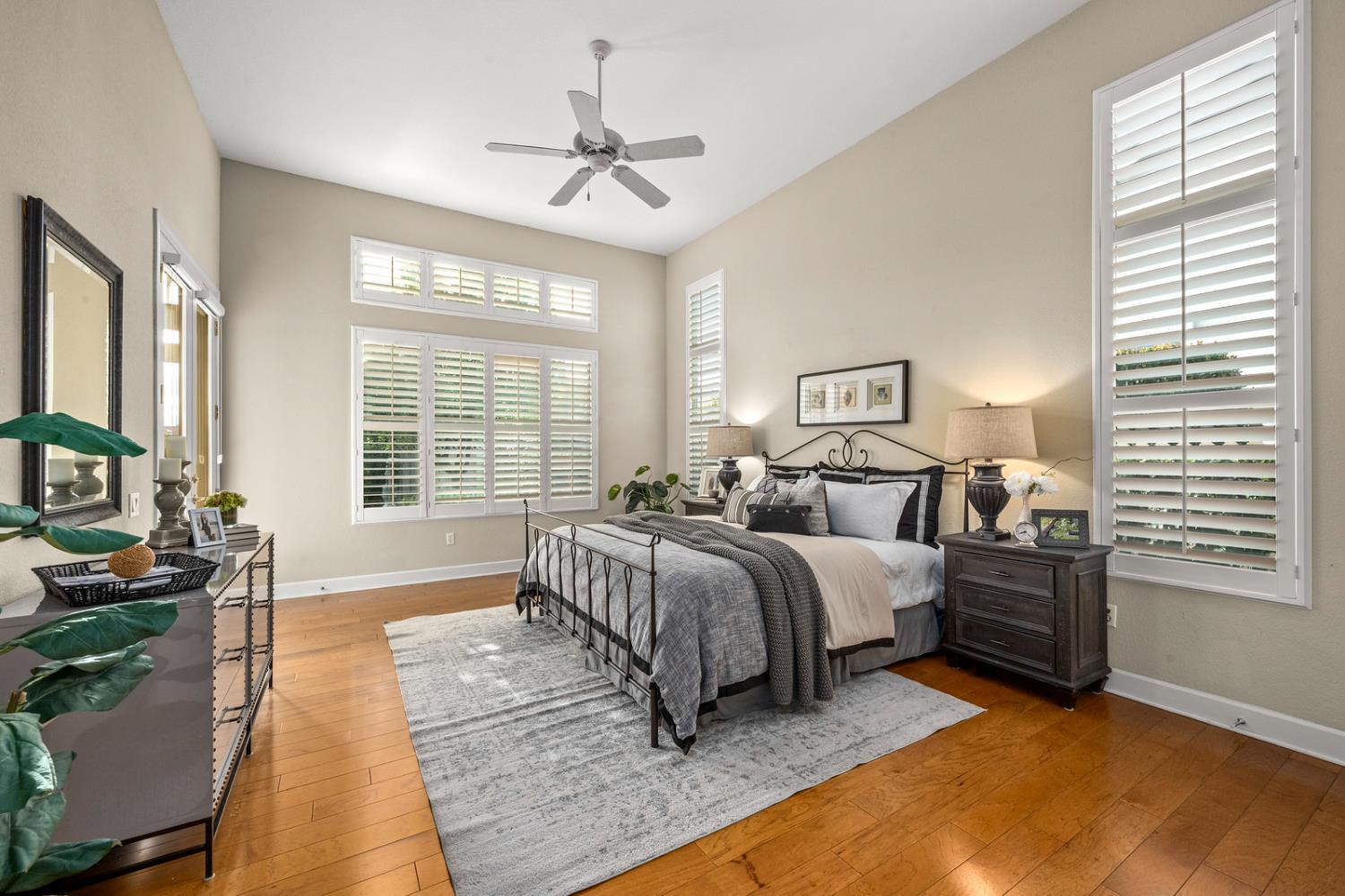 856 Mossy Ridge Lane Lincoln, CA 95648 - Photo 22 of 44 a spacious bedroom with a bed a couch and large windows