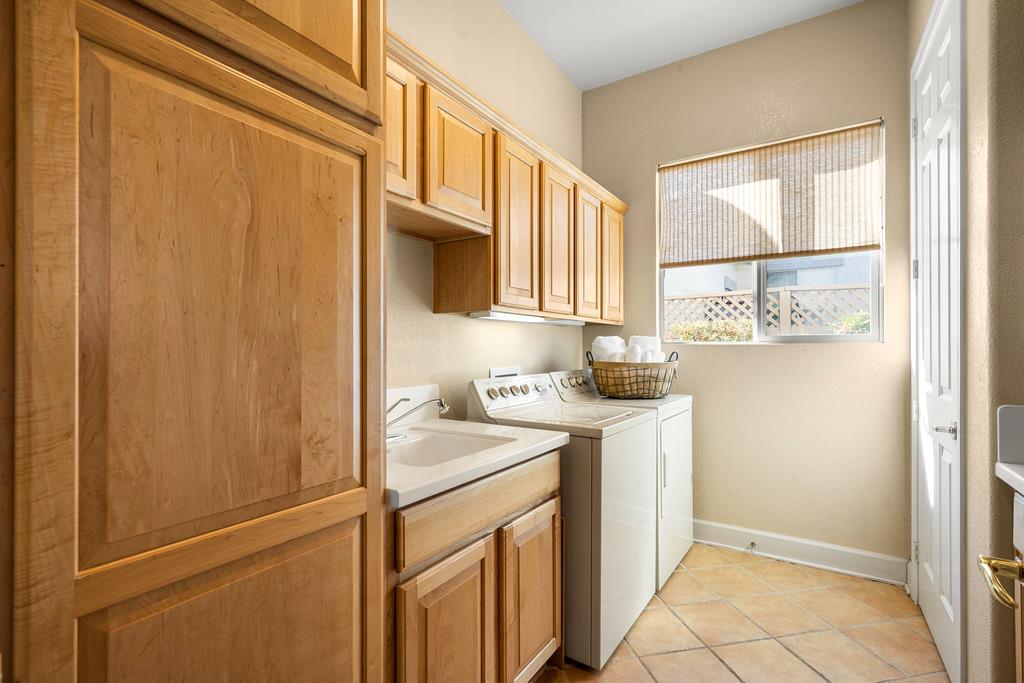 856 Mossy Ridge Lane Lincoln, CA 95648 - Photo 29 of 44 a utility room with cabinets washer and dryer