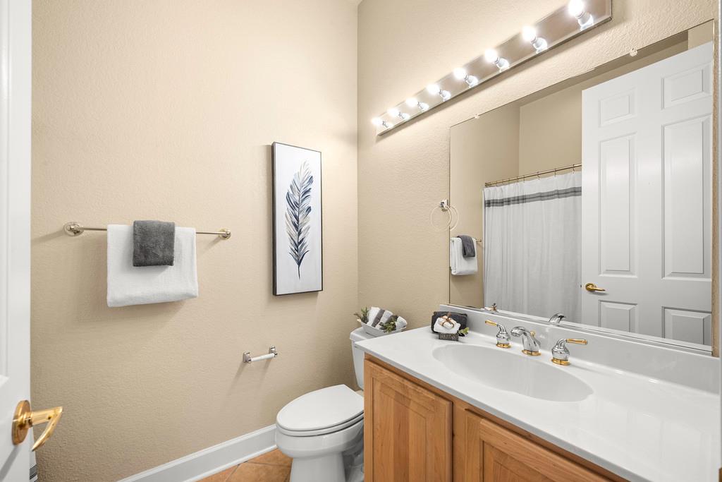 856 Mossy Ridge Lane Lincoln, CA 95648 - Photo 31 of 44 a bathroom with a toilet sink and mirror
