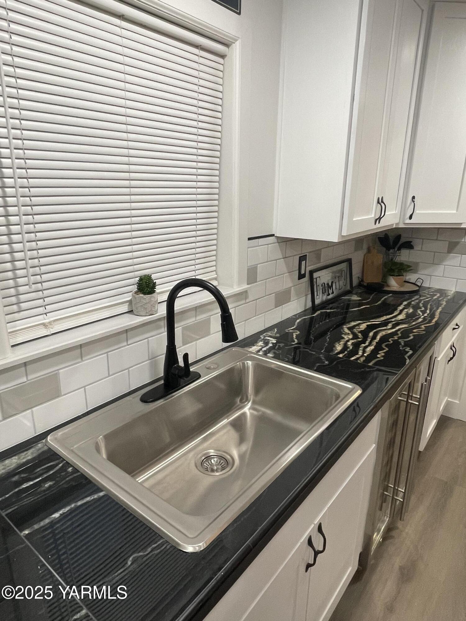 212 West Boulevard, Unit S Granger, WA 98932 - Photo 17 of 40 a close view of a sink a counter and appliances in a kitchen
