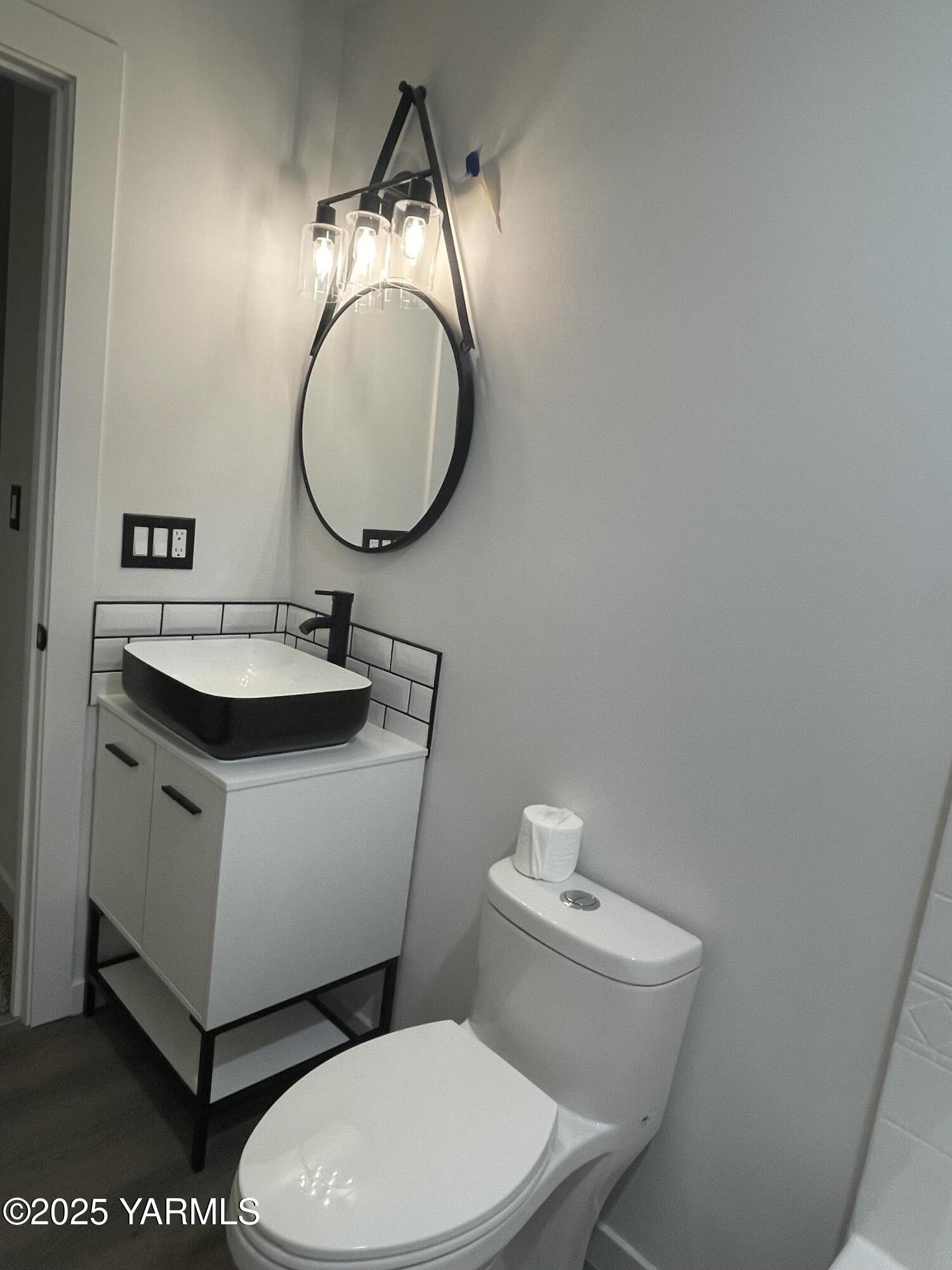 212 West Boulevard, Unit S Granger, WA 98932 - Photo 24 of 40 a bathroom with a toilet sink and mirror