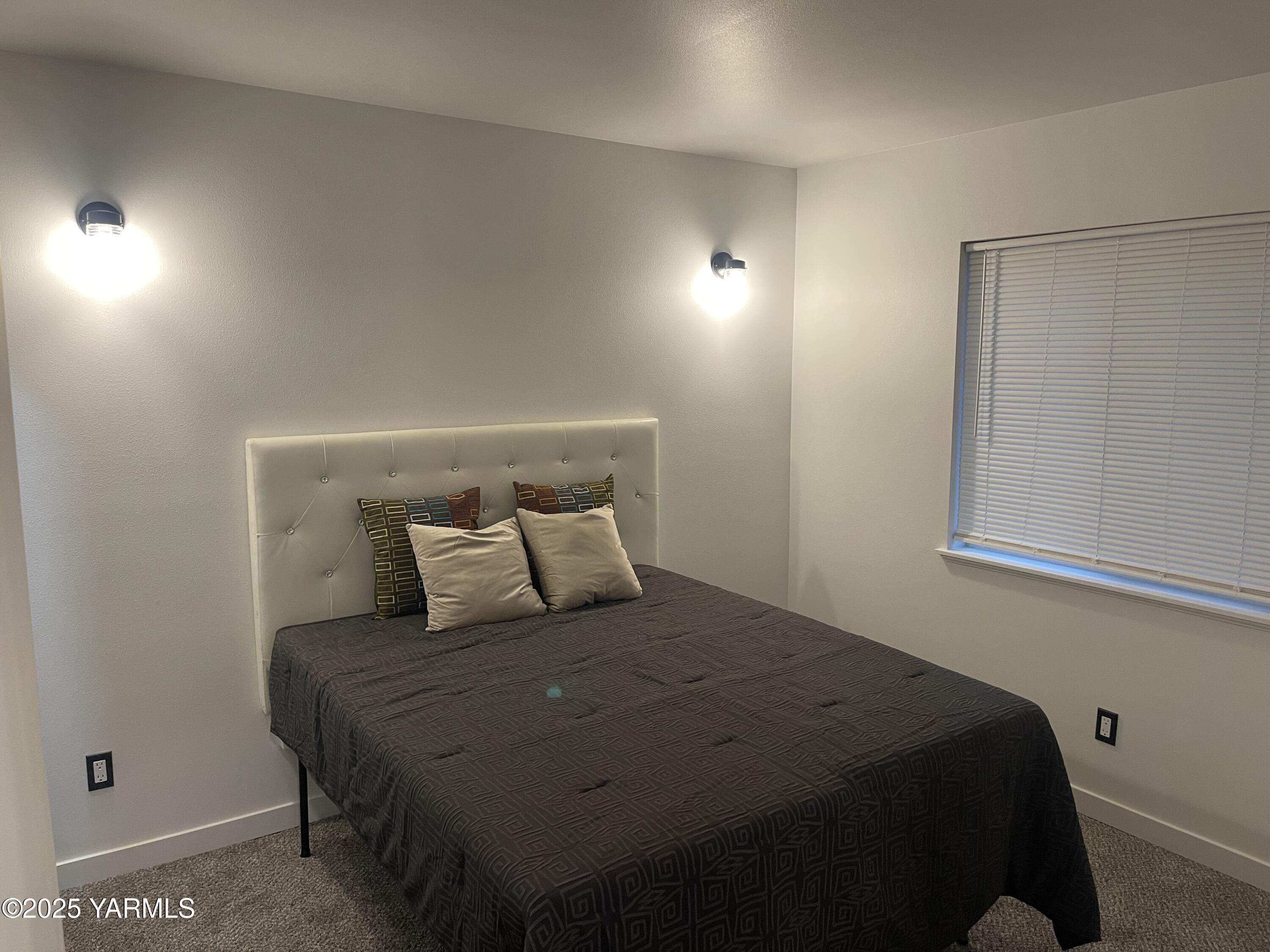 212 West Boulevard, Unit S Granger, WA 98932 - Photo 34 of 40 a bedroom with a bed and a window