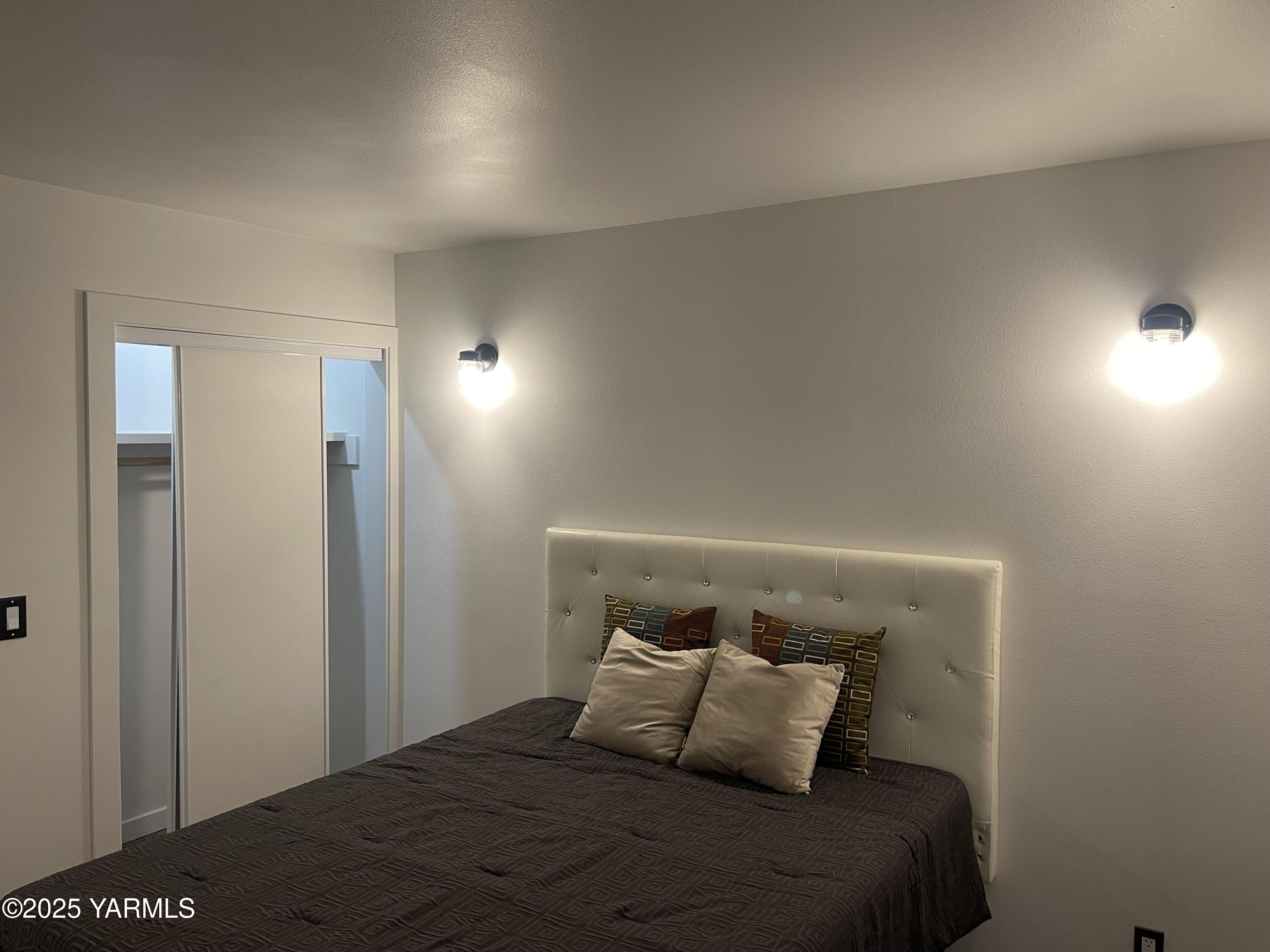 212 West Boulevard, Unit S Granger, WA 98932 - Photo 35 of 40 a bedroom with a bed and a night stand