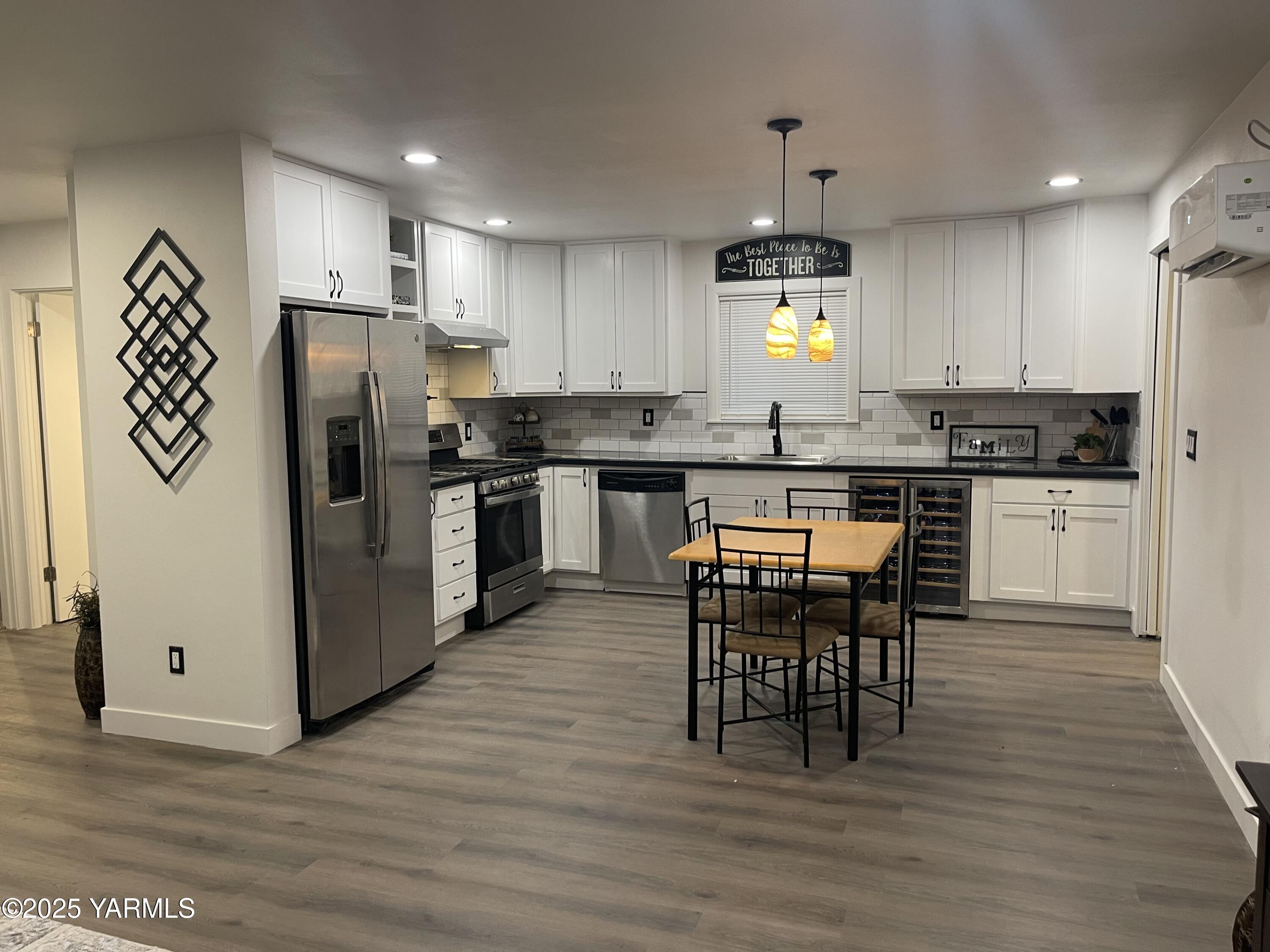 212 West Boulevard, Unit S Granger, WA 98932 - Photo 7 of 40 a kitchen with stainless steel appliances granite countertop a stove refrigerator and cabinets