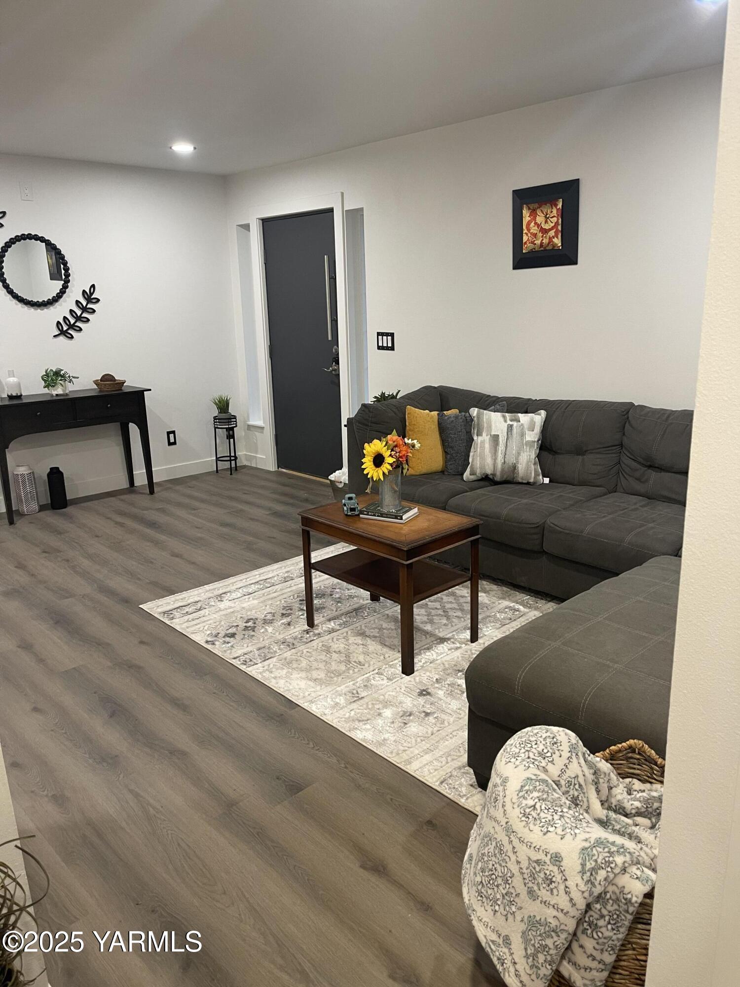 212 West Boulevard, Unit S Granger, WA 98932 - Photo 10 of 40 a living room with furniture and a wooden floor