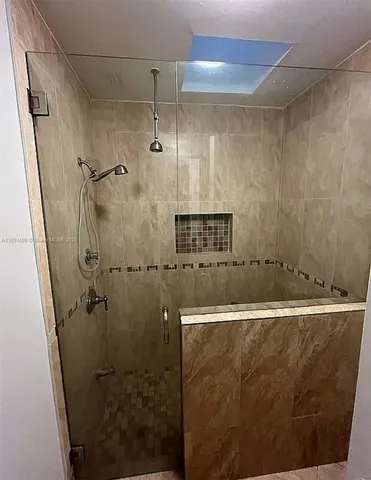 a bathroom with a shower and a mirror