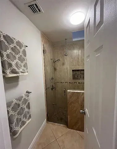 a bathroom with a shower and a curtain