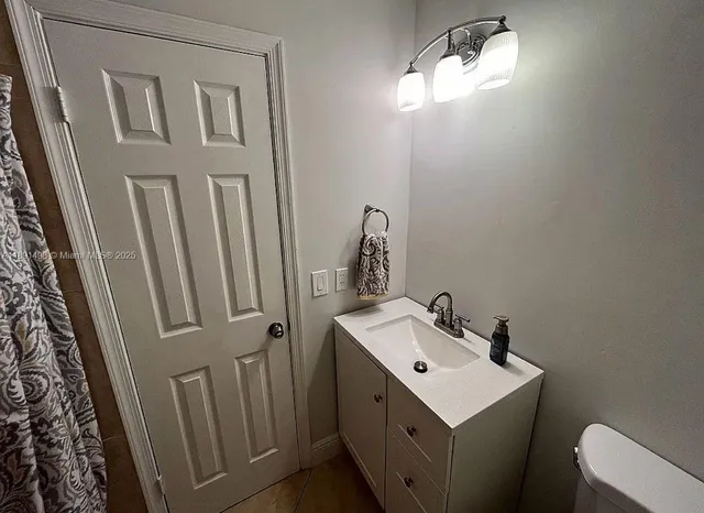 a kitchen with stainless steel appliances granite countertop a refrigerator a sink and a stove with wooden floor