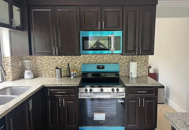 a kitchen with a sink and a refrigerator