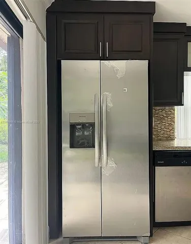 a kitchen with a refrigerator and a sink