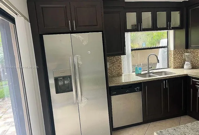 a kitchen with stainless steel appliances a stove sink and cabinets