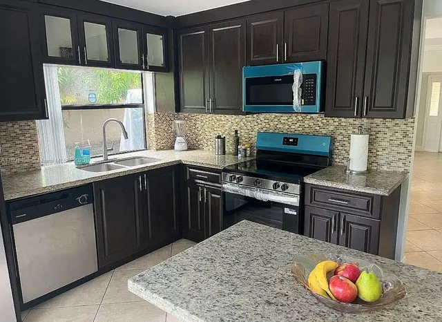 a view of a yard with plants and a tree