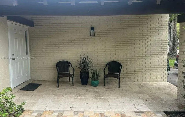 a couple of chairs and a table in a patio