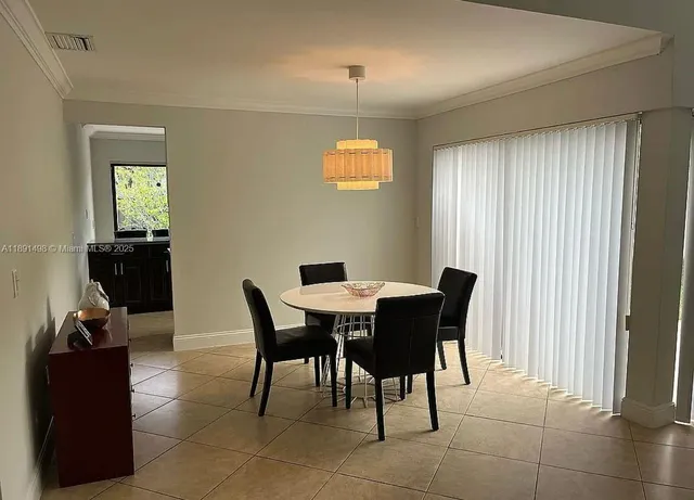 a view of a dining room with furniture and window
