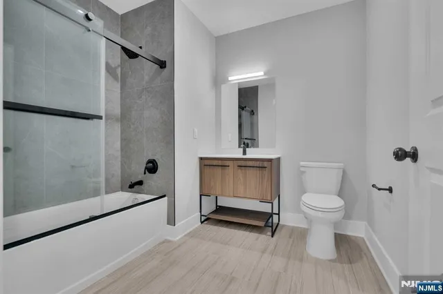 a bathroom with a toilet sink and shower
