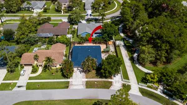 an aerial view of residential houses with outdoor space and street view