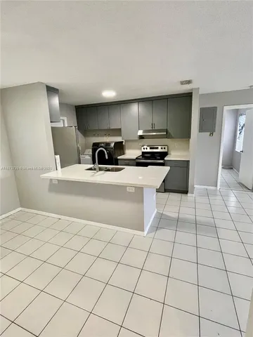 a view of a kitchen with microwave and a sink