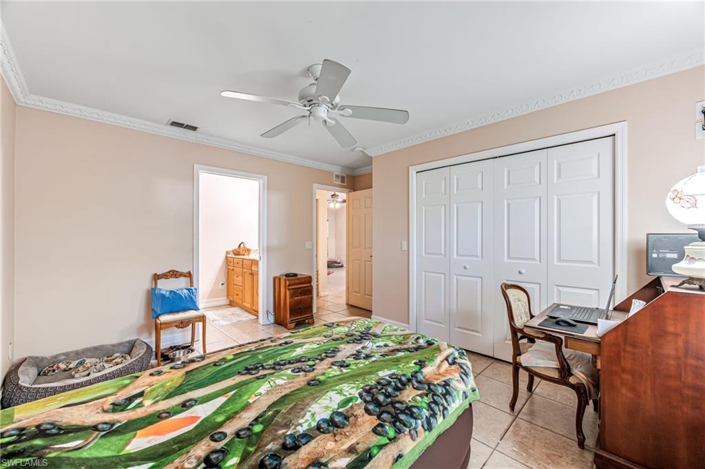 724 Pine Cone Lane Naples, FL 34104 - Photo 11 of 45 a bedroom with a bed and furniture