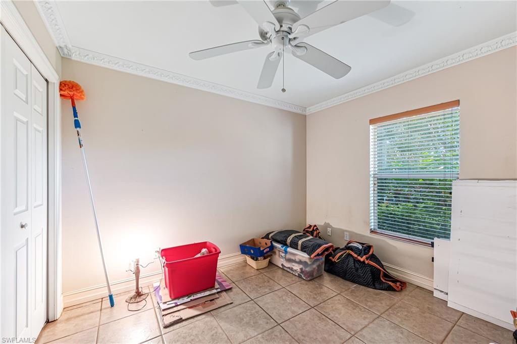 724 Pine Cone Lane Naples, FL 34104 - Photo 13 of 45 a bedroom with furniture and a large window