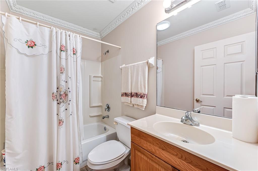 724 Pine Cone Lane Naples, FL 34104 - Photo 14 of 45 a bathroom with a sink a toilet a tub and shower