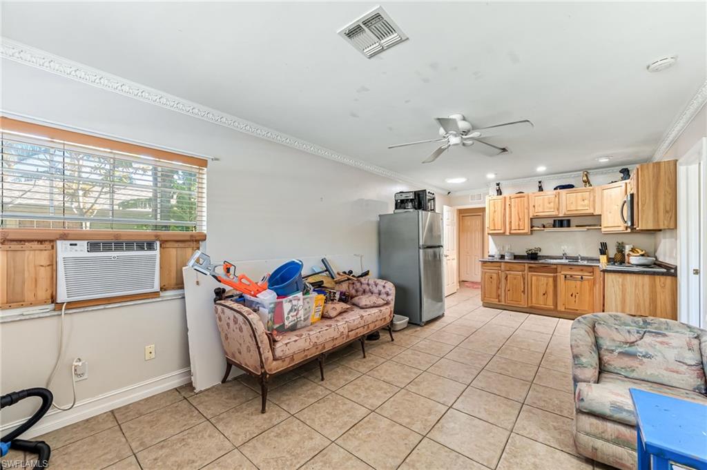 724 Pine Cone Lane Naples, FL 34104 - Photo 15 of 45 a kitchen with granite countertop a sink refrigerator and cabinets