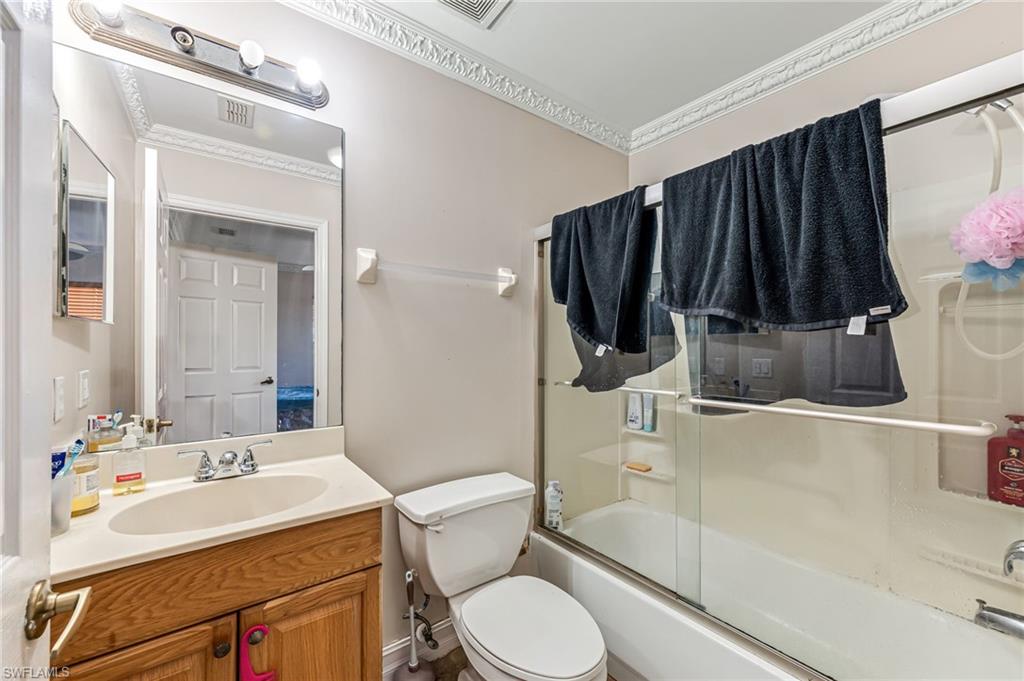 724 Pine Cone Lane Naples, FL 34104 - Photo 20 of 45 a bathroom with a sink a toilet and shower