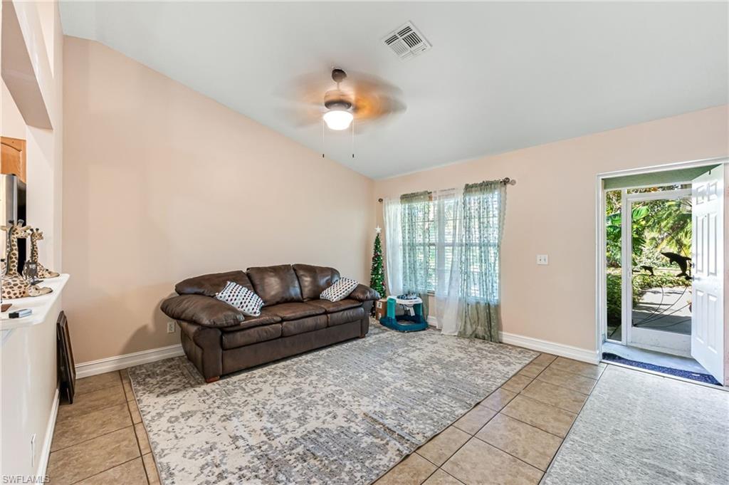 724 Pine Cone Lane Naples, FL 34104 - Photo 23 of 45 a living room with furniture and a large window