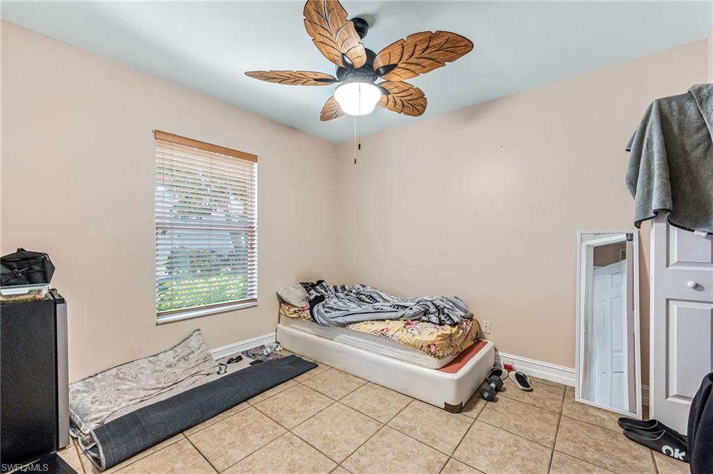 724 Pine Cone Lane Naples, FL 34104 - Photo 27 of 45 a bedroom with bed and a window