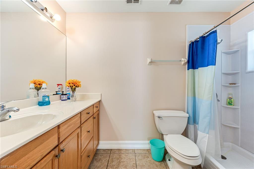 724 Pine Cone Lane Naples, FL 34104 - Photo 30 of 45 a bathroom with a sink toilet and shower