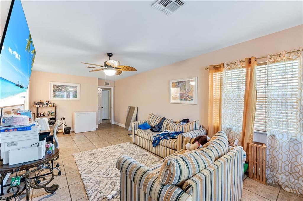 724 Pine Cone Lane Naples, FL 34104 - Photo 31 of 45 a living room with furniture and a large window