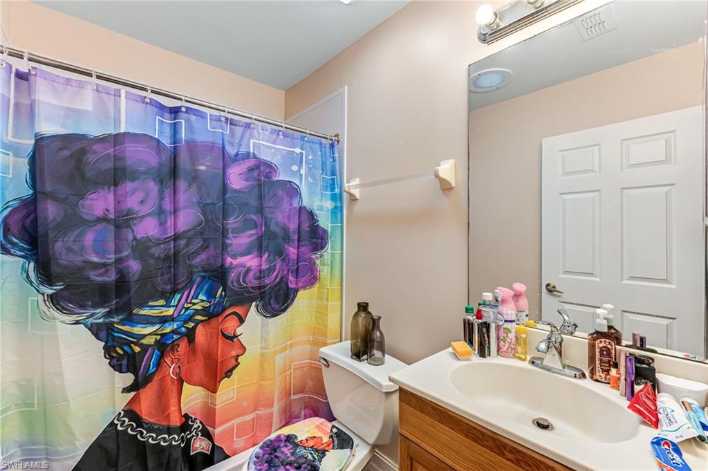 724 Pine Cone Lane Naples, FL 34104 - Photo 34 of 45 a bathroom with a sink and a mirror