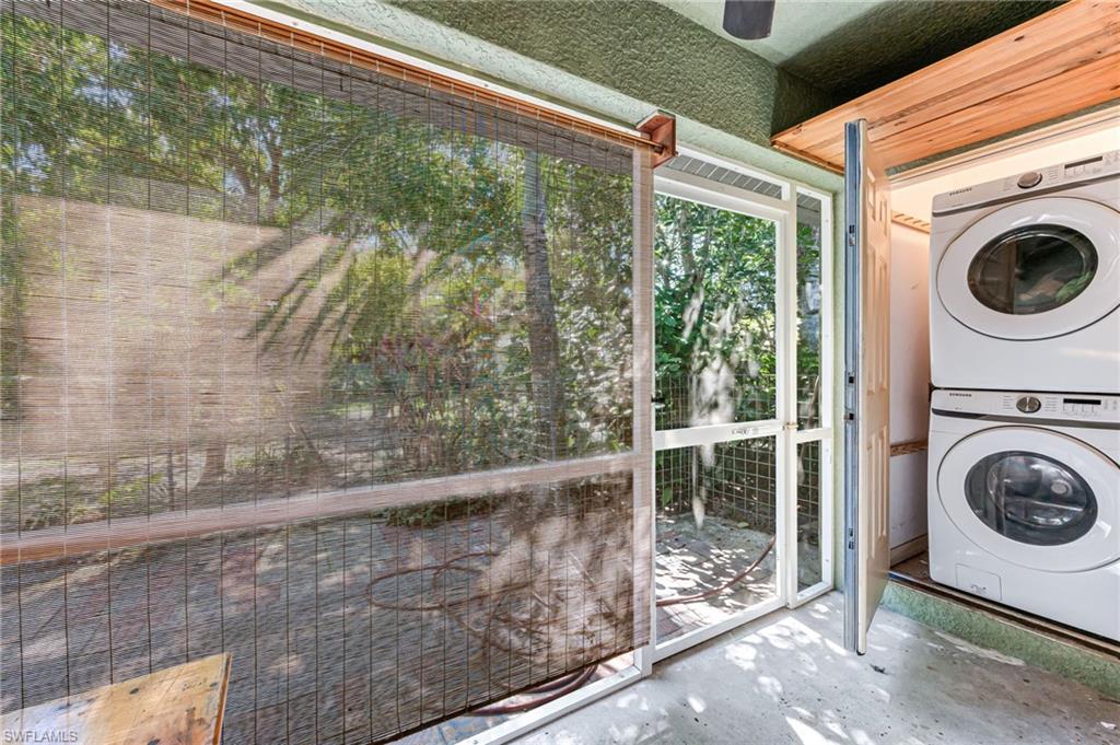724 Pine Cone Lane Naples, FL 34104 - Photo 35 of 45 a view of a hallway with washer and dryer