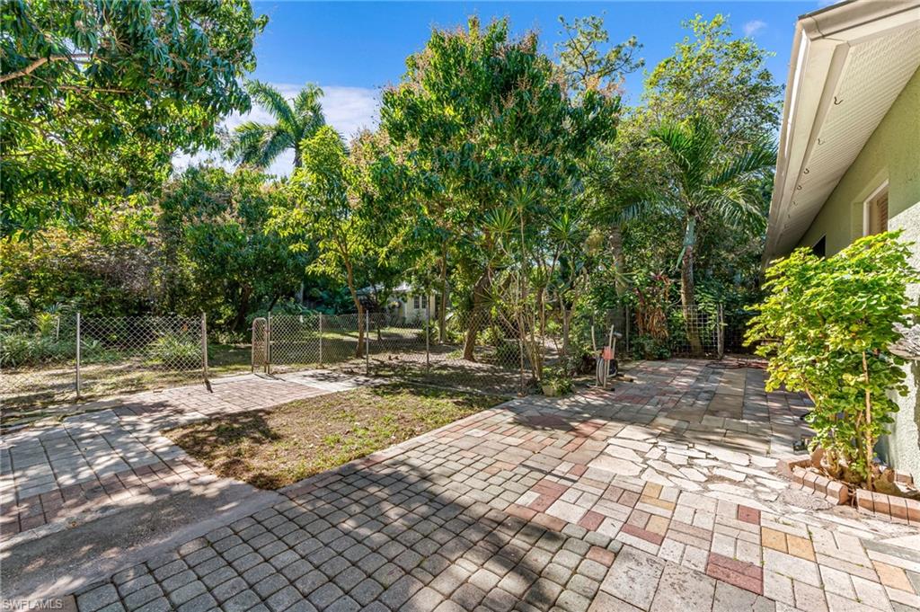724 Pine Cone Lane Naples, FL 34104 - Photo 38 of 45 a backyard of a house with lots of green space