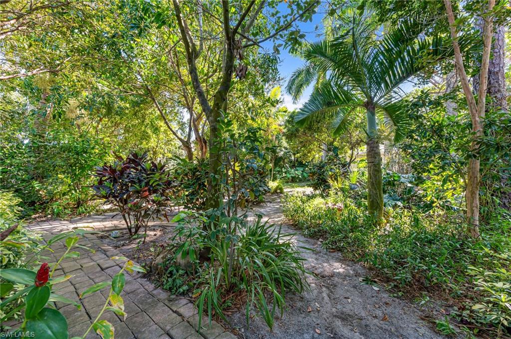 724 Pine Cone Lane Naples, FL 34104 - Photo 40 of 45 a view of a garden
