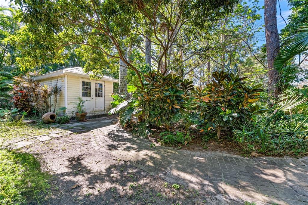 724 Pine Cone Lane Naples, FL 34104 - Photo 42 of 45 a white house that has a tree in front of it