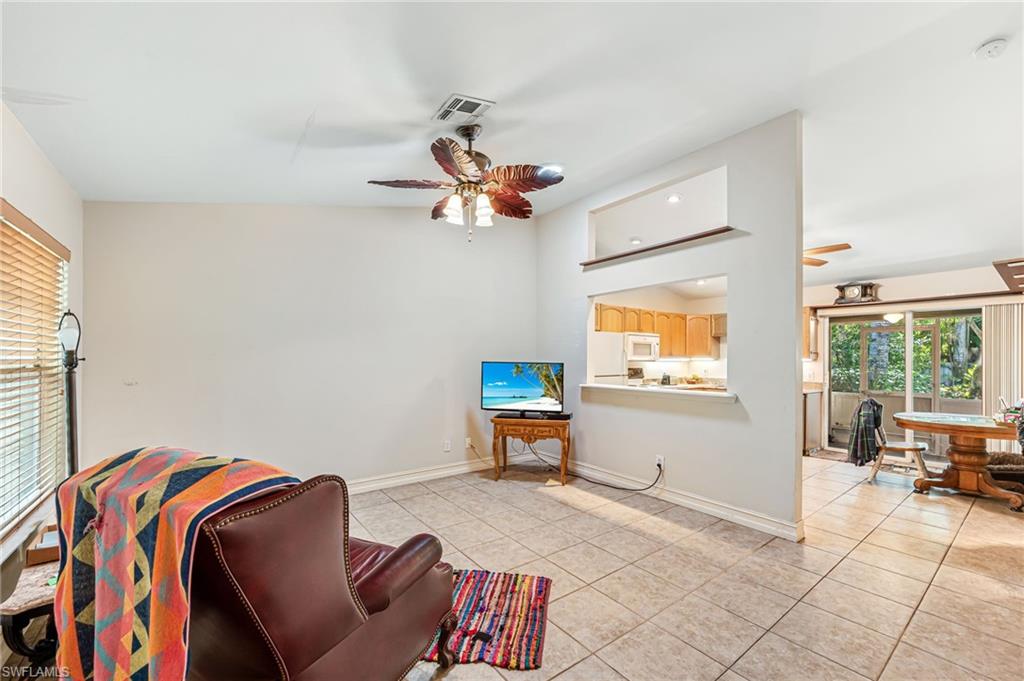 724 Pine Cone Lane Naples, FL 34104 - Photo 5 of 45 a bedroom with furniture and a window