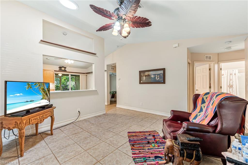 724 Pine Cone Lane Naples, FL 34104 - Photo 7 of 45 a living room with furniture and a window