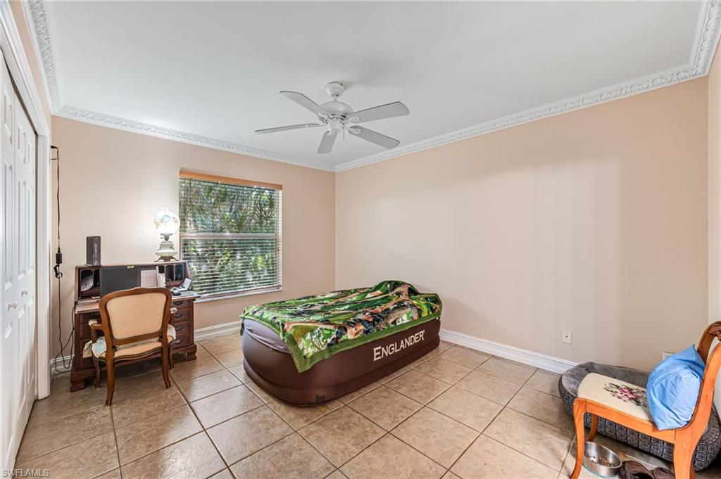 724 Pine Cone Lane Naples, FL 34104 - Photo 10 of 45 a living room with furniture and a window