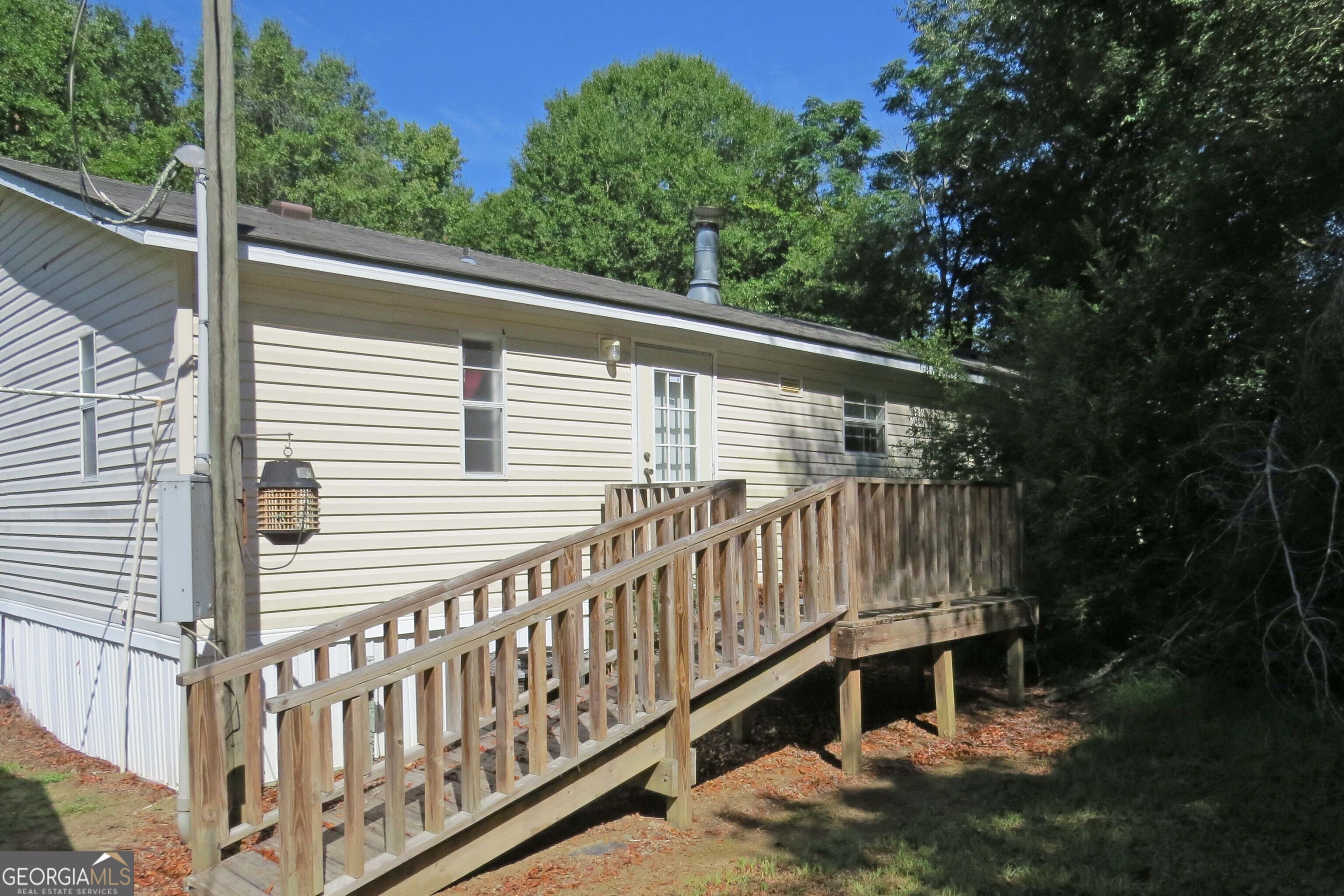 241 Mount Galilee Church Road Jacksonville, GA 31544 - Photo 2 of 19 a view of a wooden house with a small yard and wooden fence
