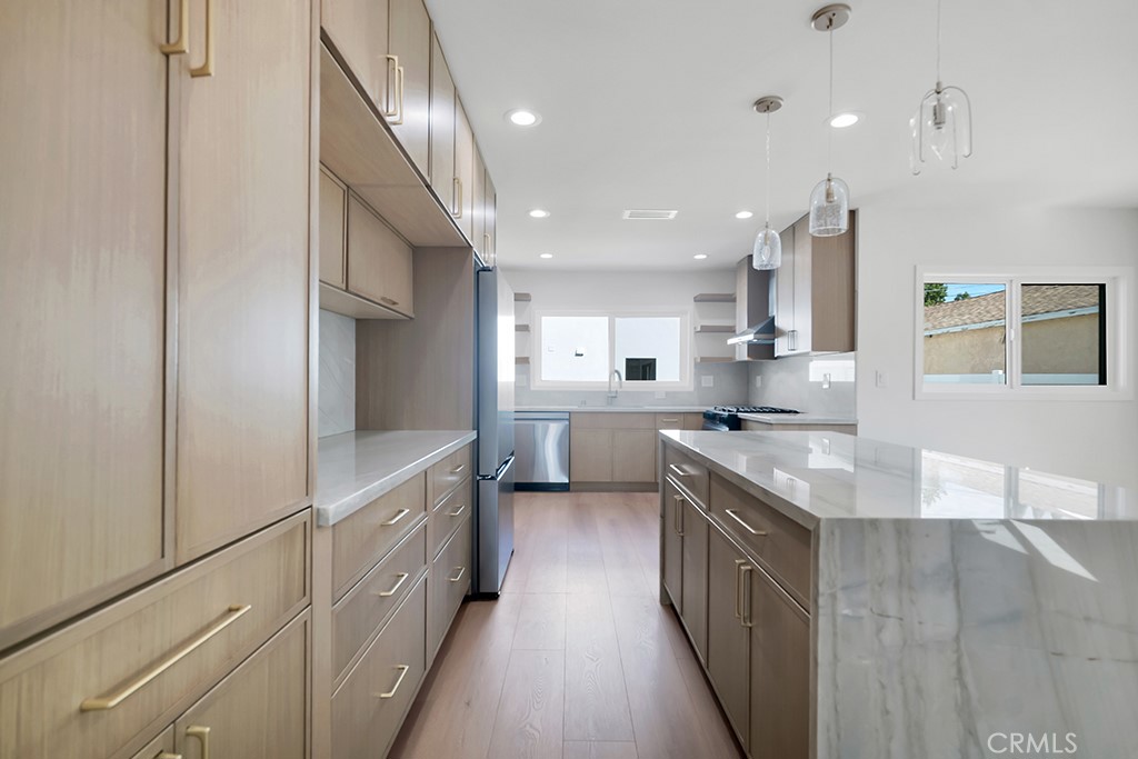 6156 Colbath Avenue Valley Glen, CA 91401 - Photo 11 of 62 a large kitchen with stainless steel appliances lots of counter top space