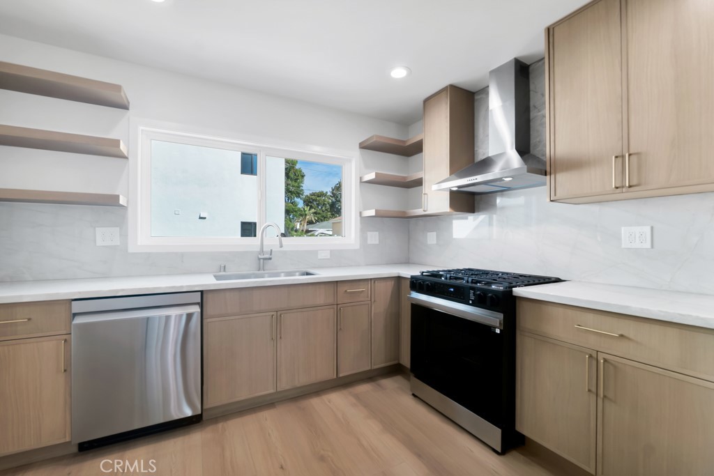 6156 Colbath Avenue Valley Glen, CA 91401 - Photo 12 of 62 a kitchen with stainless steel appliances granite countertop a sink stove and cabinets