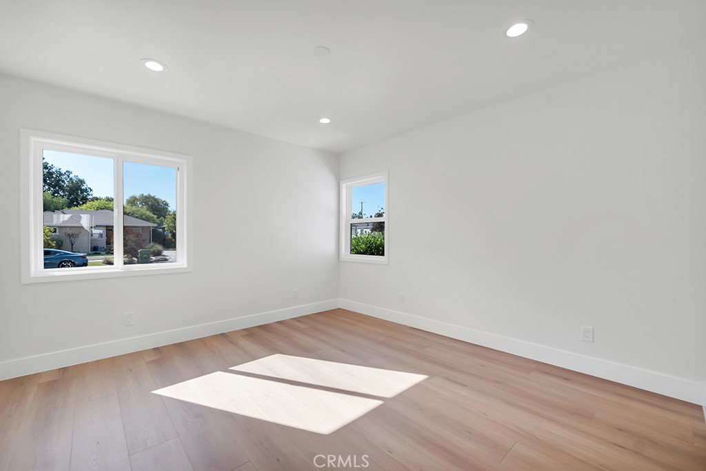 6156 Colbath Avenue Valley Glen, CA 91401 - Photo 13 of 62 an empty room with wooden floor and windows